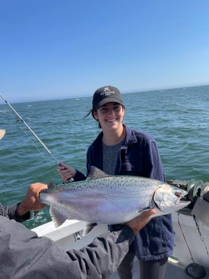 a person holding a fish in the water