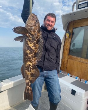 a person holding a fish in the water