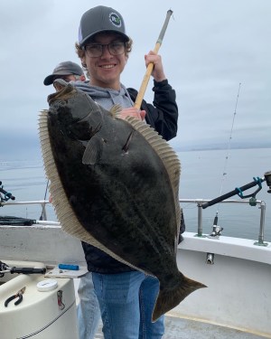 a person holding a fish on a boat