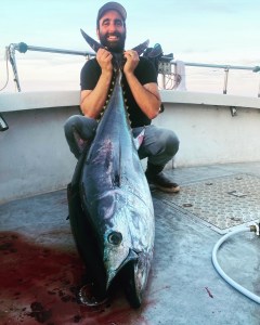 a person holding a fish in the water