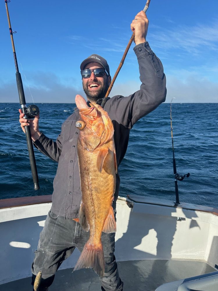 a person holding a fish in the water